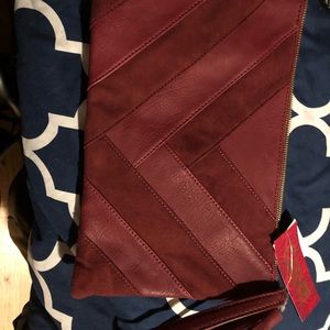 Carlos Santana burgundy clutch